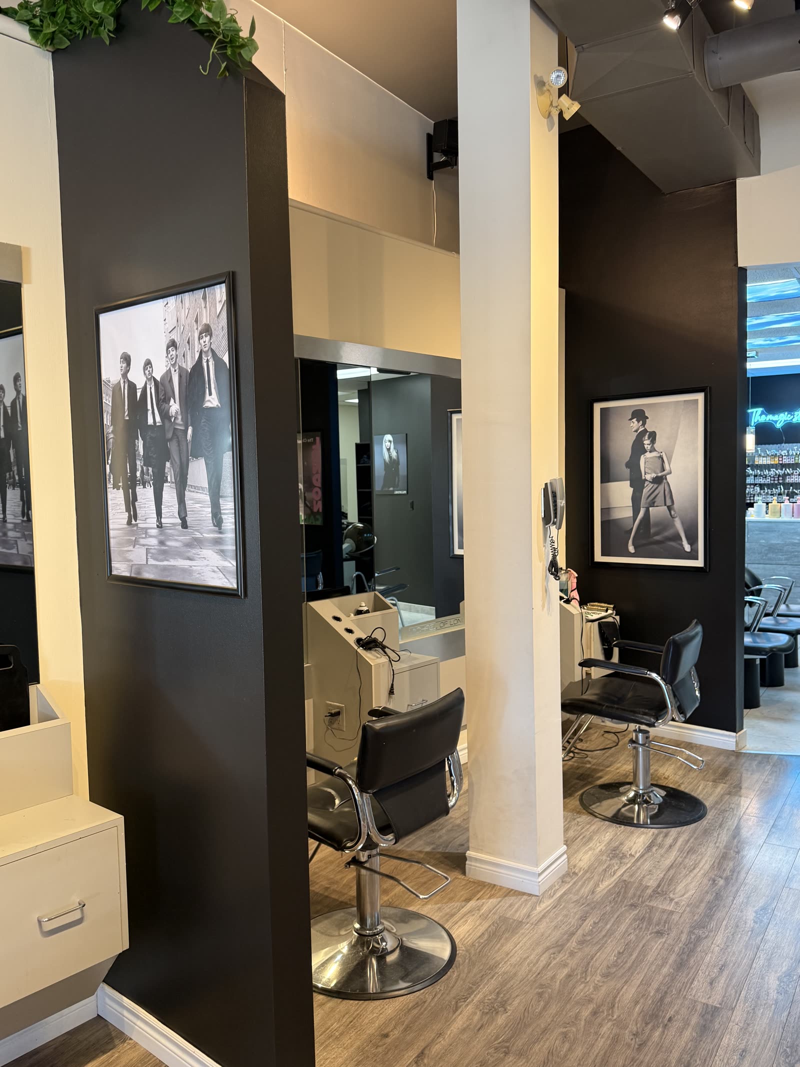 London-inspired styling area at Michael of London Salon & Spa in St. Catharines, with black & white Beatles portrait and styling chairs